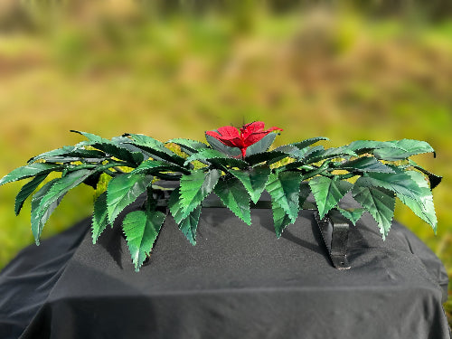 Steel wreath is made from mild steel and coated to protect it from the sun. it is painted green with a red flower. this is perfect for a loved one headstone.