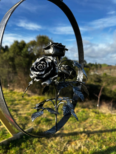 Here is another angle of the rose garland, suspended in steel and overlooking a beautiful rural view in the garden of All Fired Up