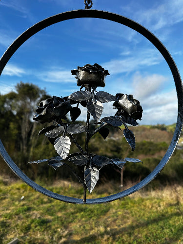Here we have 3 roses on one stem, encircled by a ring of solid steel and hanging from a central point. Great for outdoors in the garden or inside from a wall hanger