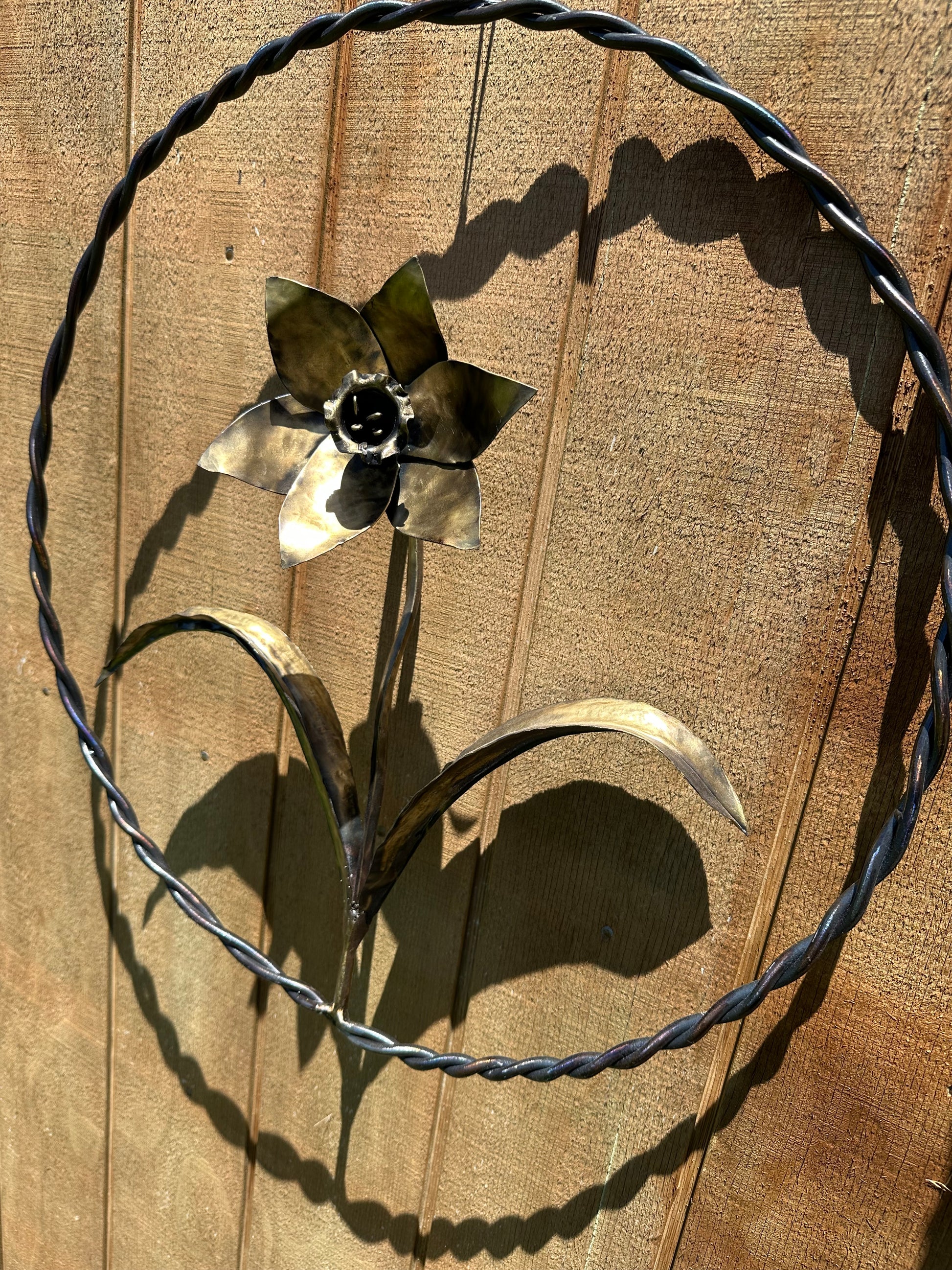 Hand-forged steel daffodil sculpture in a 40cm metal ring.