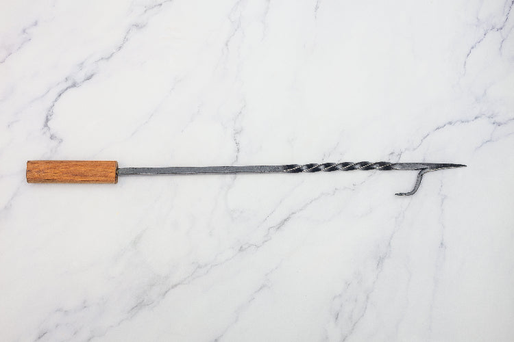 fire poker made by NZ blacksmith. this has a steel spike and a hard wood handle. these are normally 60cm long but can be made to any custom lentgth