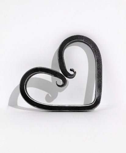 Handcrafted wrought iron heart, a timeless symbol of love and strength, elegantly forged for lasting beauty and sentiment.
