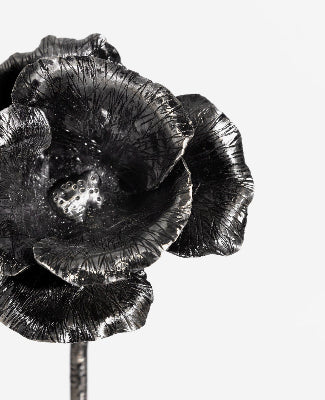 this traditional poppy made from metal is a close up shot featuring the extreme texture placed by hand to give the natural effect of the petals in the steel. 