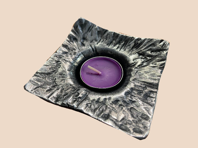 an up close view of one of the tealight candle holders and the detail in the steel 